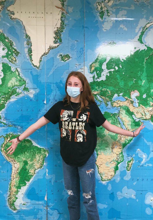 New student Ruby O. (‘22) poses in front of a world map. Her late-start transition to Taipei American School hasn’t been easy, but her many years of travelling and experience living abroad have helped her along the way. [KARA MURRI/THE BLUE&GOLD]