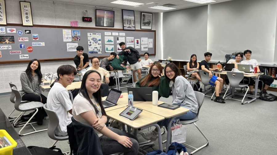 Ms. Jen-Ching and her A5 Advanced Placement (AP) Economics class smile without masks. 
