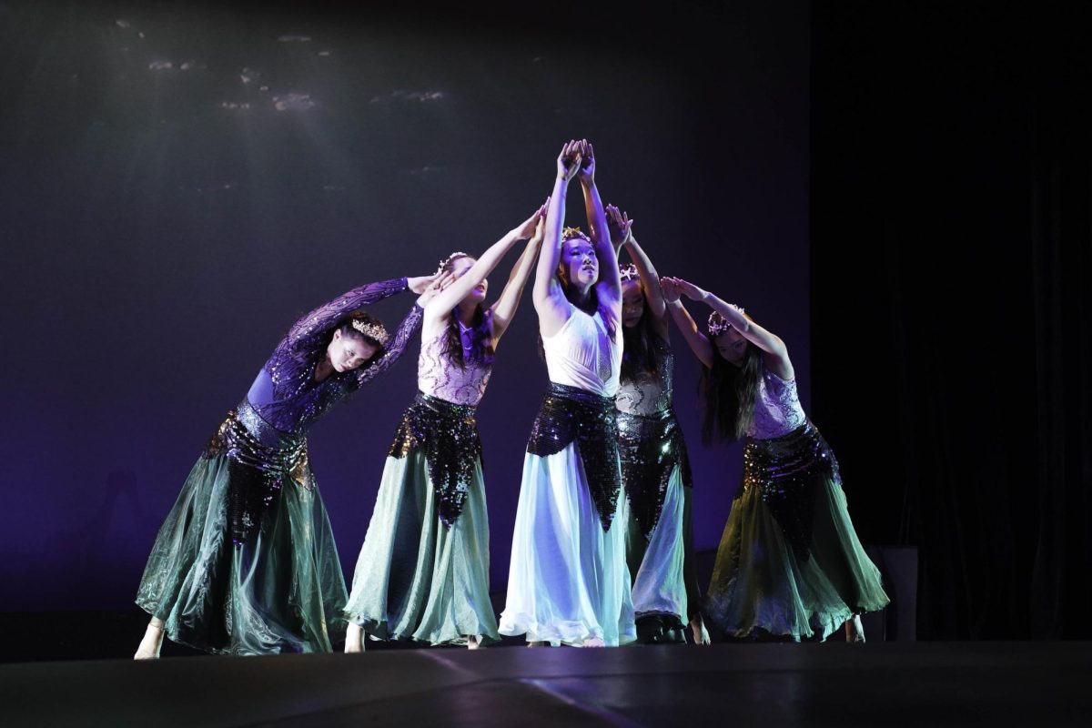 Pearl, her mother and sister dancing together. [CHARLOTTE WARMELINK/THE BLUE & GOLD]