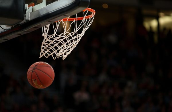 A basketball swishes through the net, completing the perfect shot. [PHOTO COURTESY OF UNSPLASH]